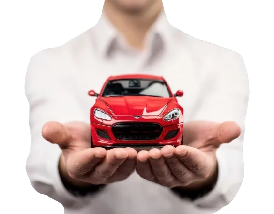 Two open hands holding a small red car
